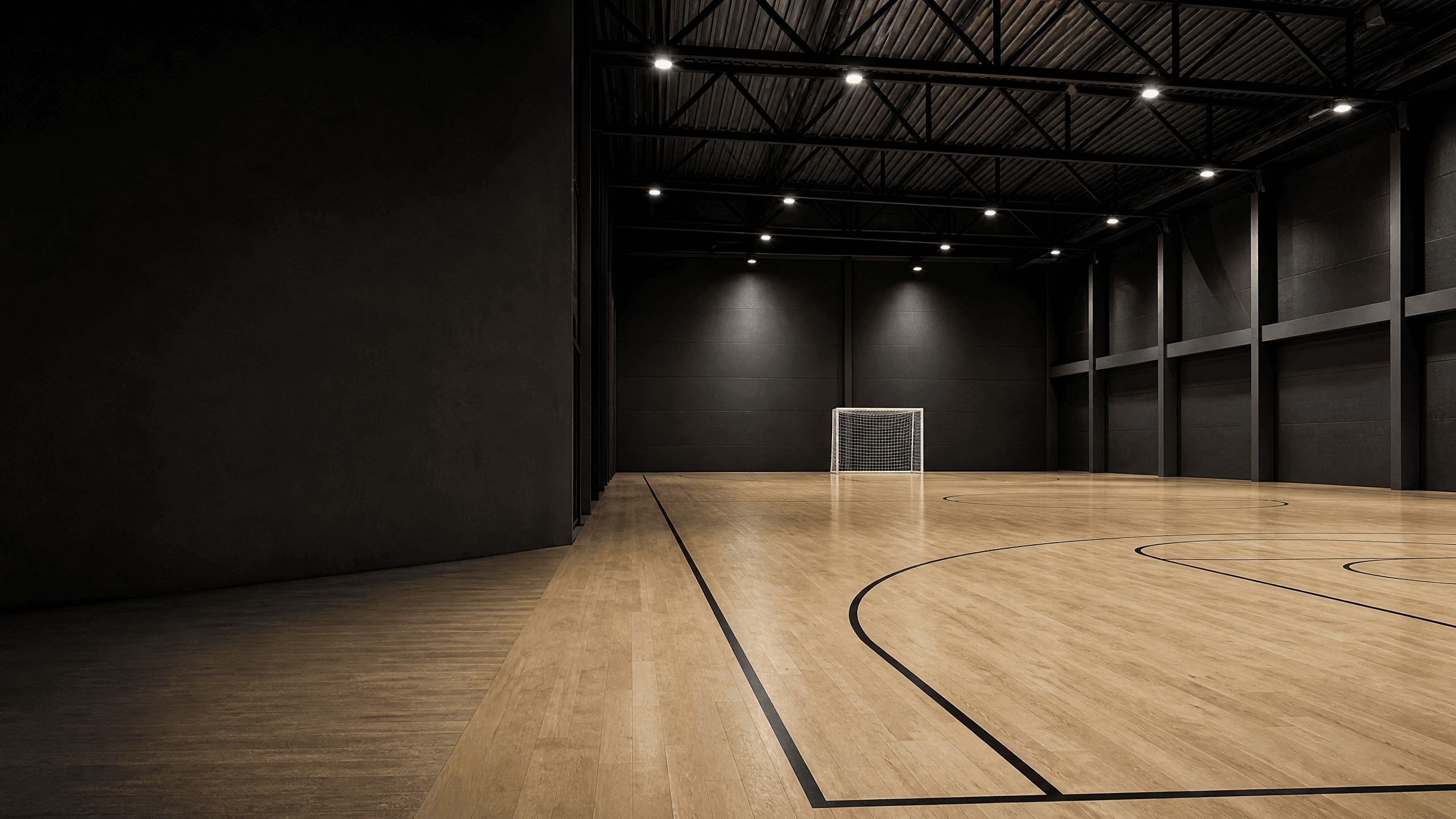 Empty modern indoor sports hall with a football goal