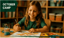A young child painting in a school classroom